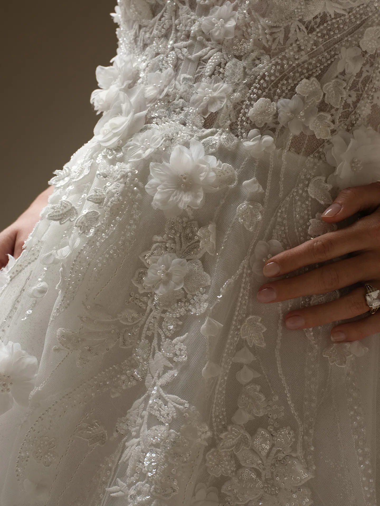 Maggie Sottero Logan close-up of lace-up beaded floral detail on A-line wedding dress