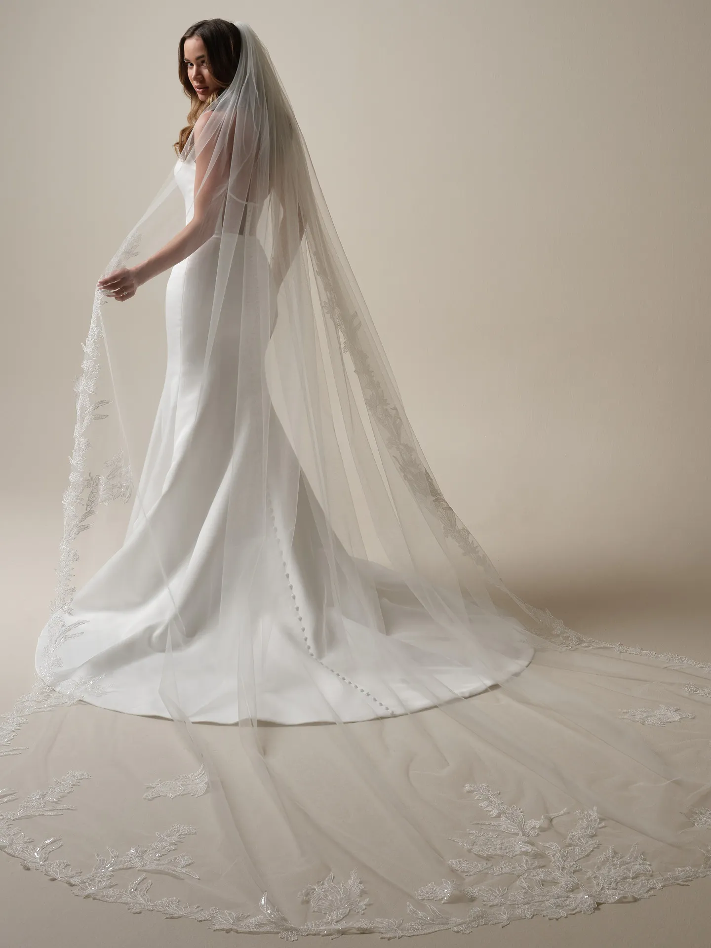 Sottero and Midgley Nesrine back view mermaid dress with long lace-trimmed veil.