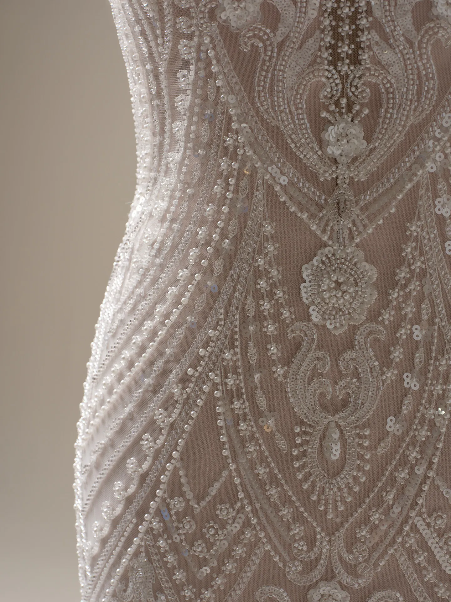 Maggie Sottero Rhett beaded sheath close-up showing intricate lace and bead details.