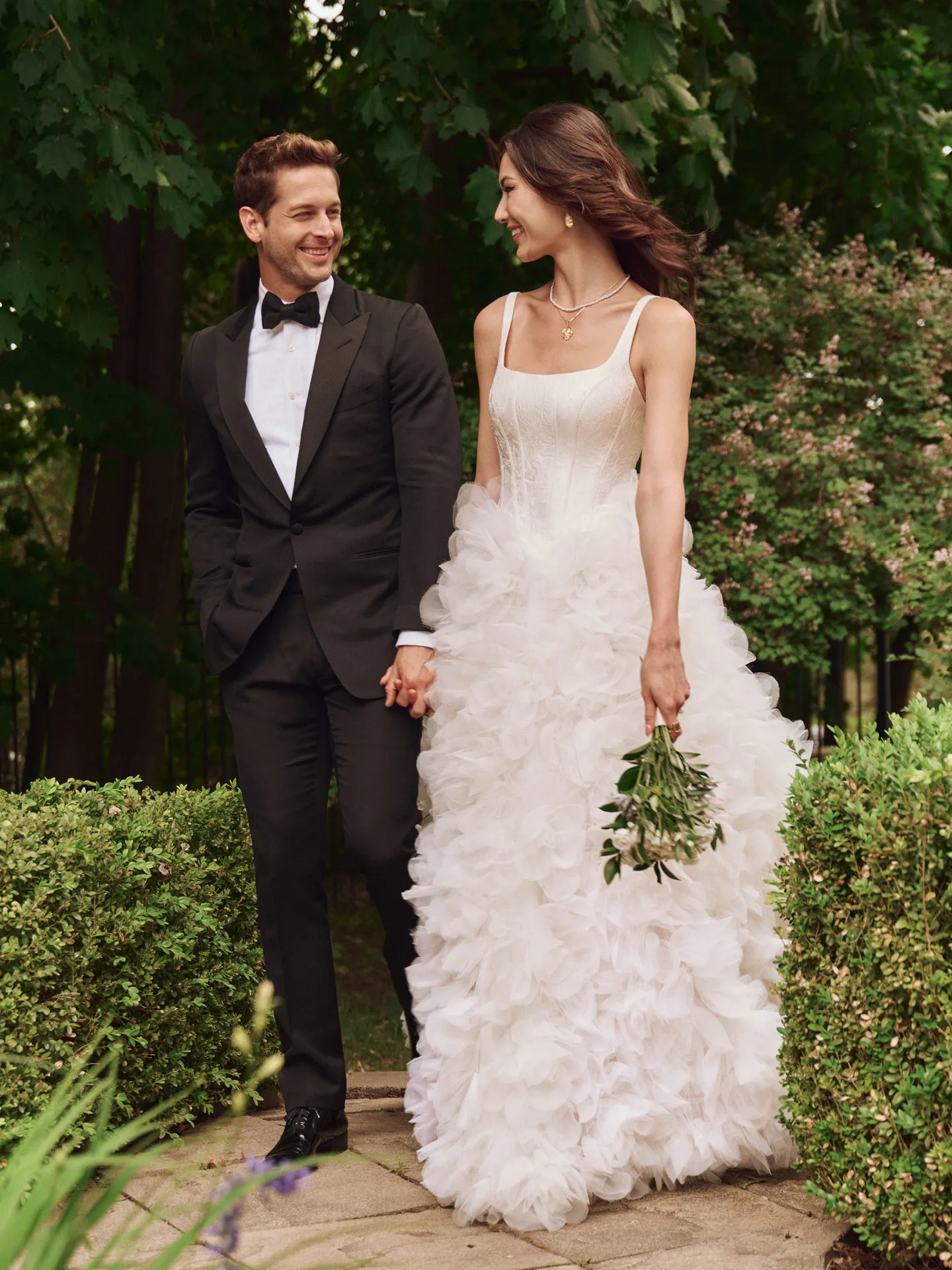 Sottero and Midgley Ross Marie ball gown, front view, with ruffle skirt, outdoors.
