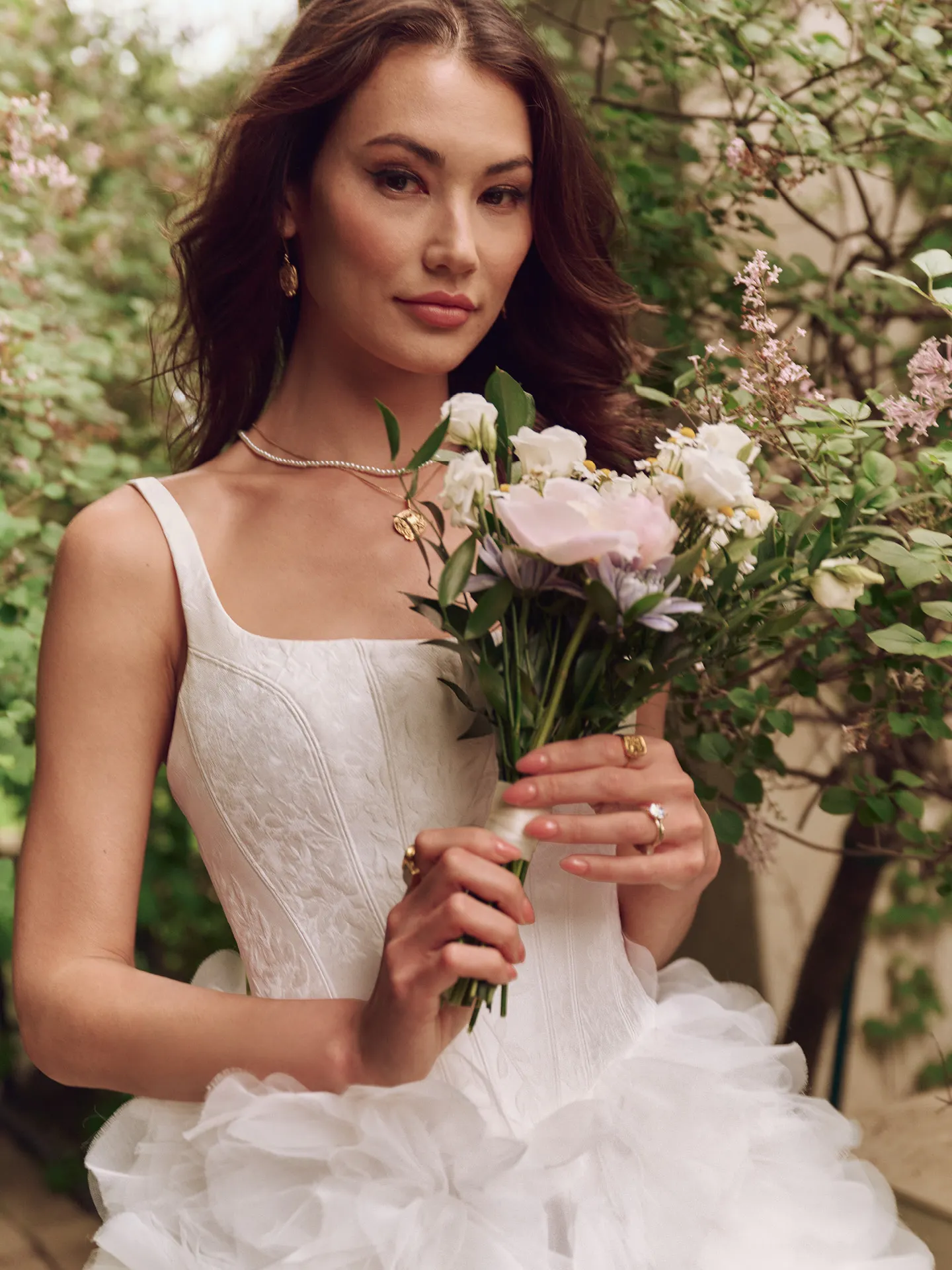 Sottero and Midgley Ross Marie ball gown, ruffle skirt, floral bouquet, garden setting.