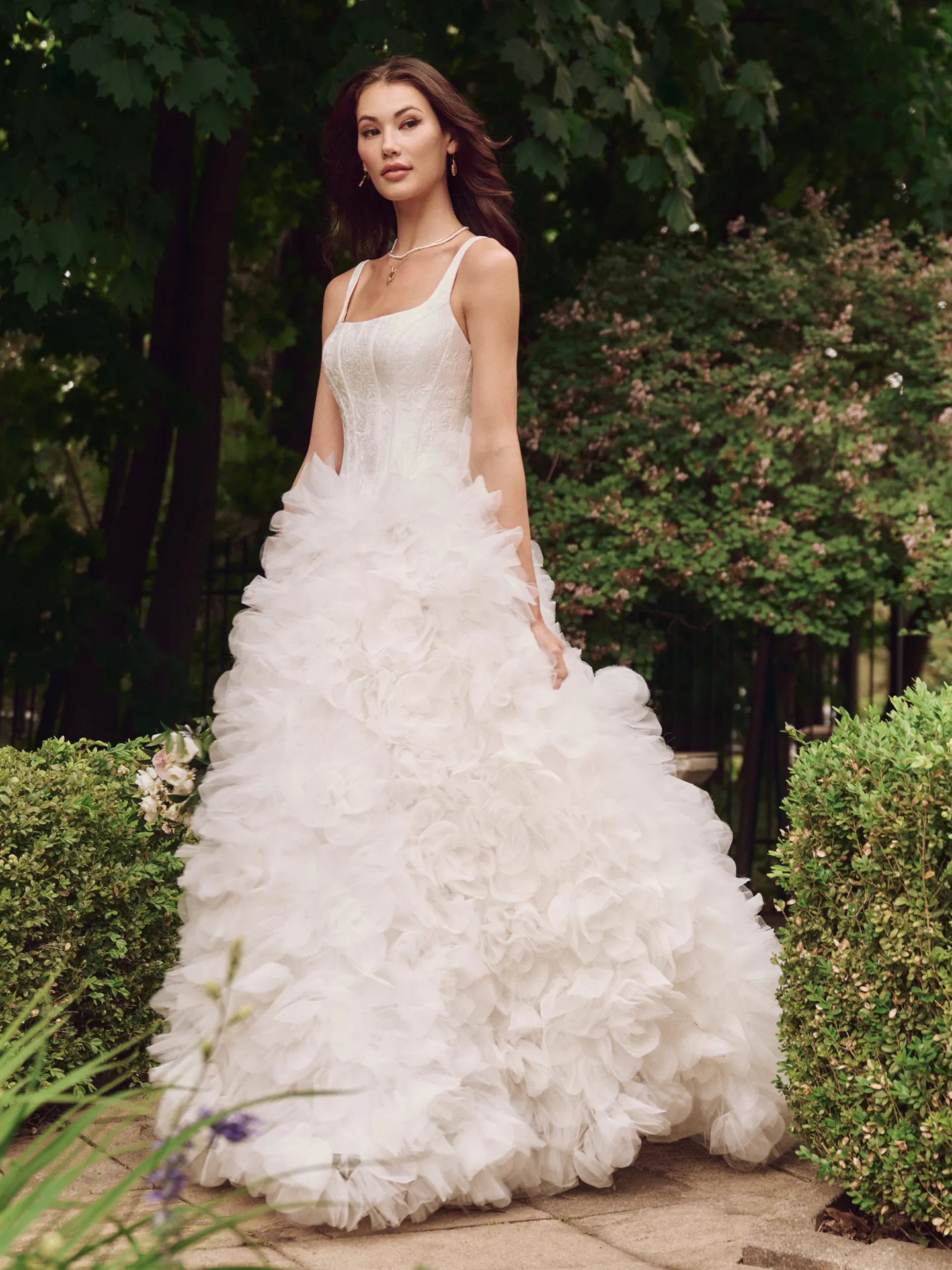 Sottero and Midgley Ross Marie front view ball gown with ruffle skirt in garden setting