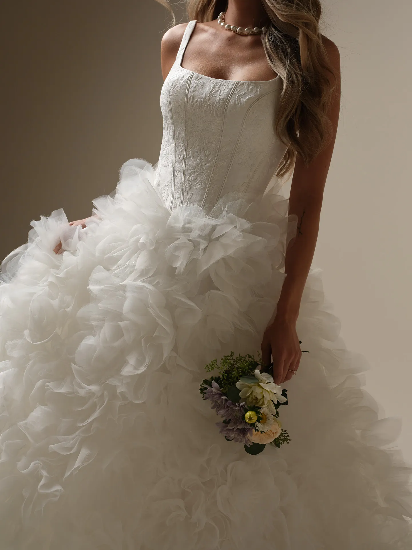 Sottero and Midgley Ross Marie ball gown front view with ruffle skirt and bouquet.