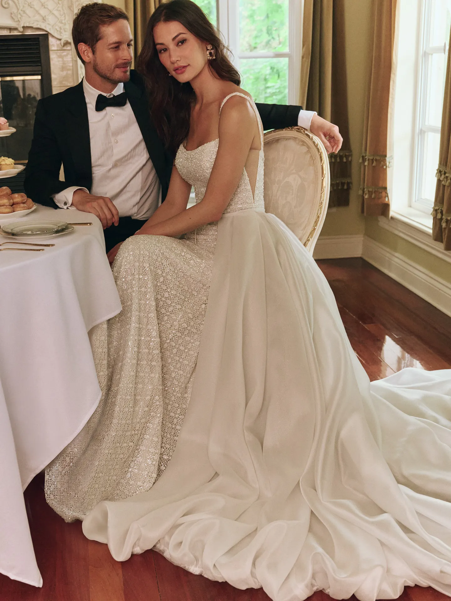 Maggie Sottero glittering sheath bridal gown with bow, side view
