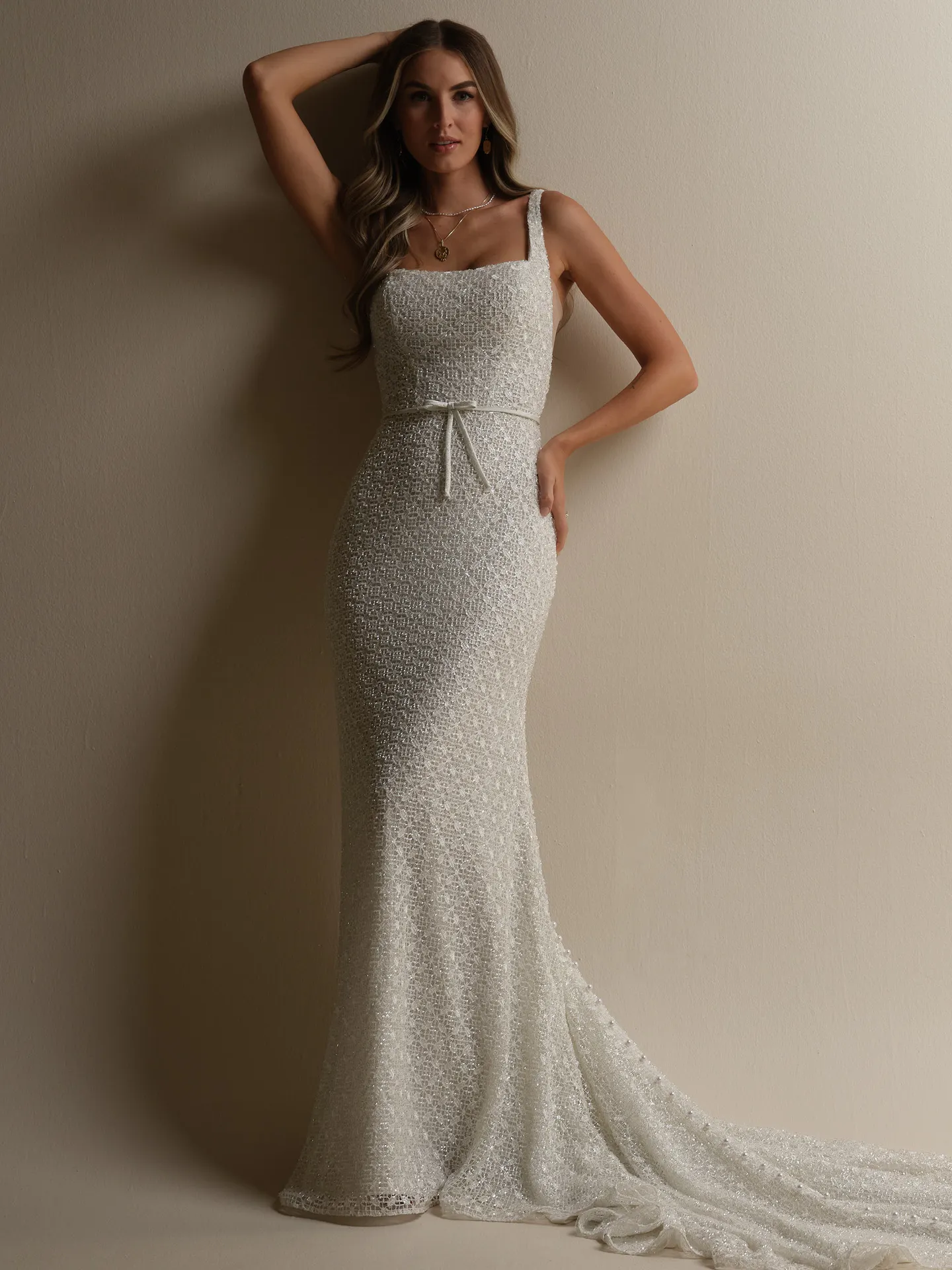 Maggie Sottero glittering sheath bridal gown with bow front view