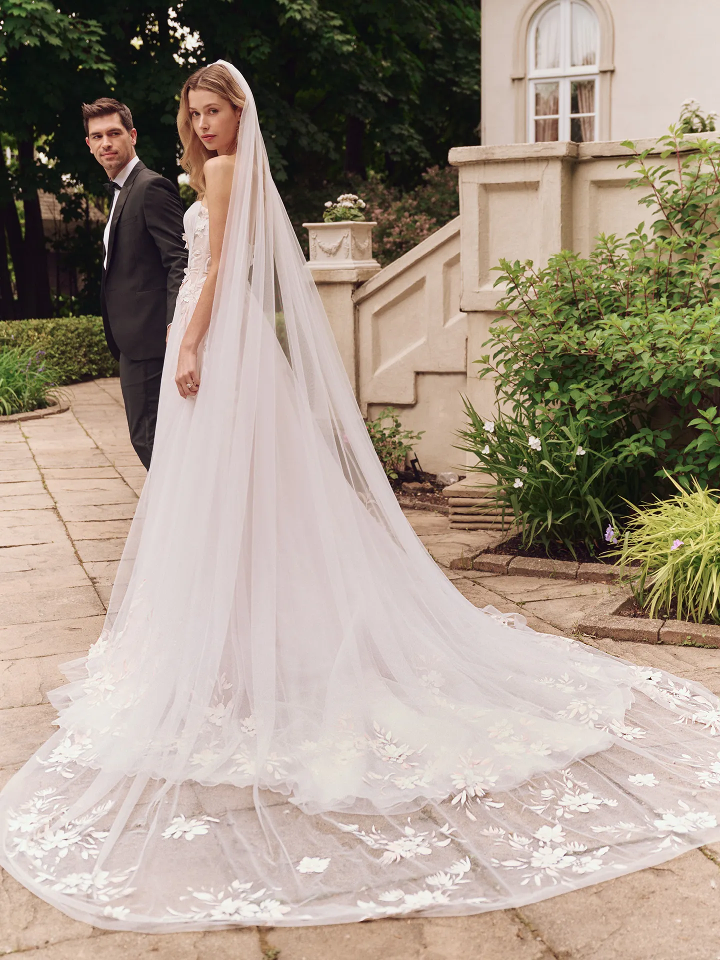Maggie Sottero Vineyard back view with floral A-line gown and long veil