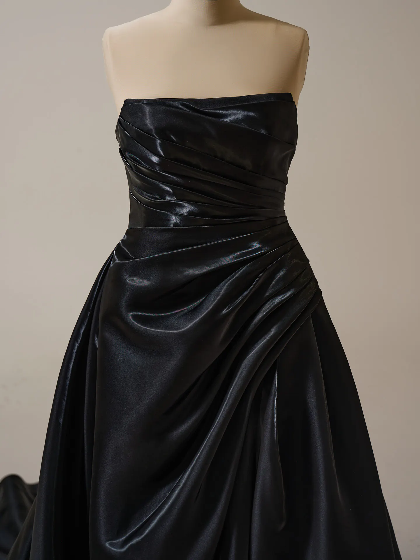 Sottero and Midgley Mirabella front view in black with pleated satin and asymmetrical draping.