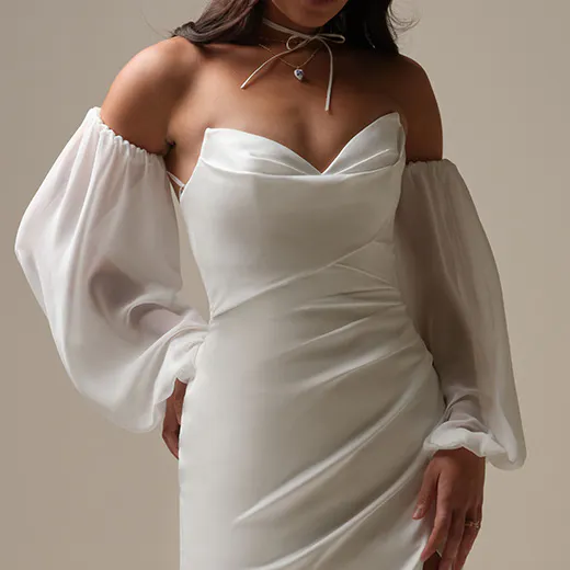 Maggie Sottero Camille front view with off-shoulder, draped satin sheath dress and puff sleeves