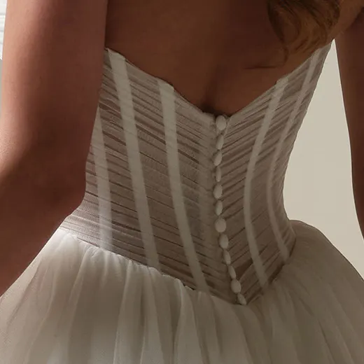 Evan pleated ball gown back view showcasing button detail by Maggie Sottero