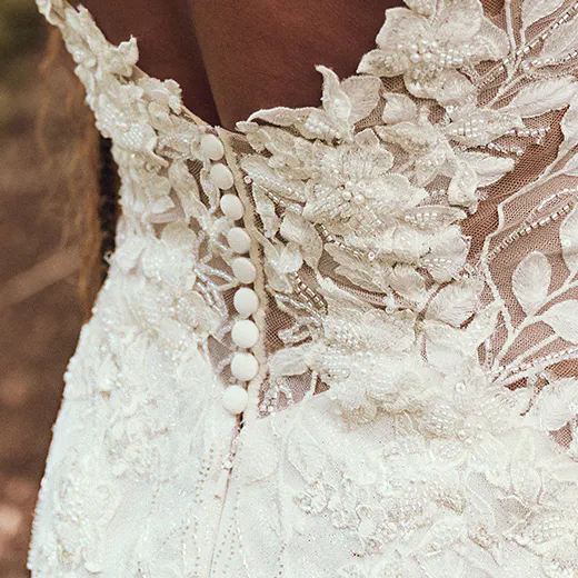 Maggie Sottero Keegan back view glittering illusion mermaid gown with floral lace buttons