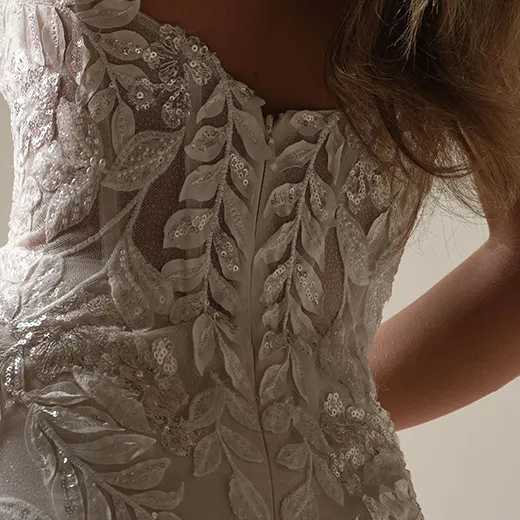 Maggie Sottero mermaid gown back view with nature-inspired sparkly lace designs.
