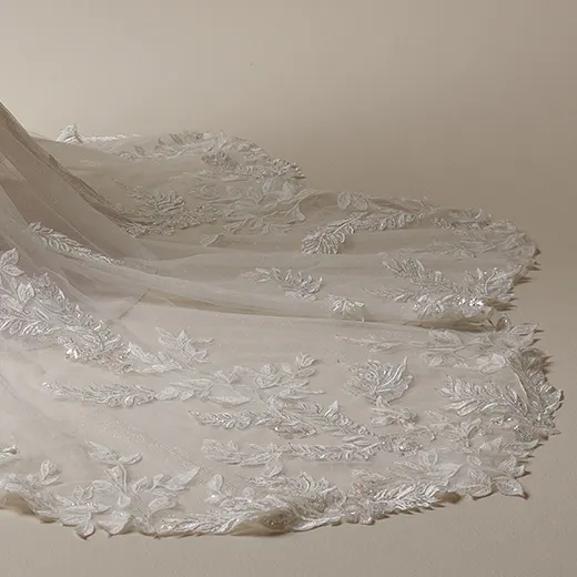 Maggie Sottero nature-inspired mermaid gown with lace train, side view.