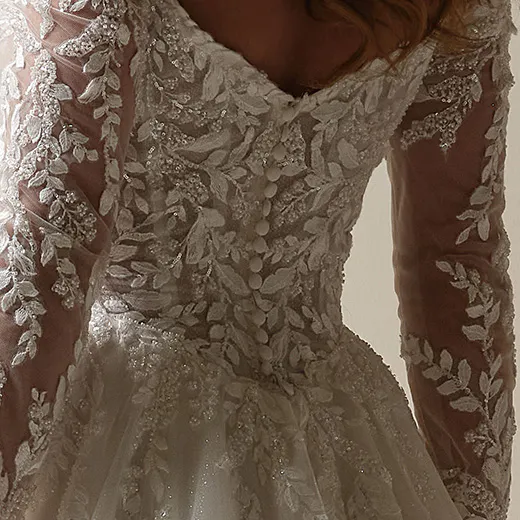 Maggie Sottero Rita back view with beaded lace detailing on long sleeves and bodice.