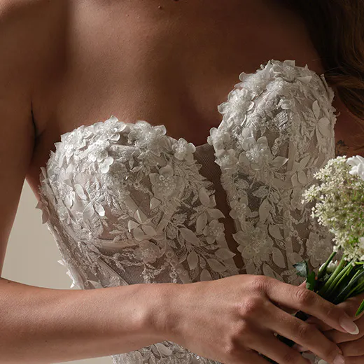 Maggie Sottero Roberta lace fit-and-flare dress front view with exposed boning and flower details.