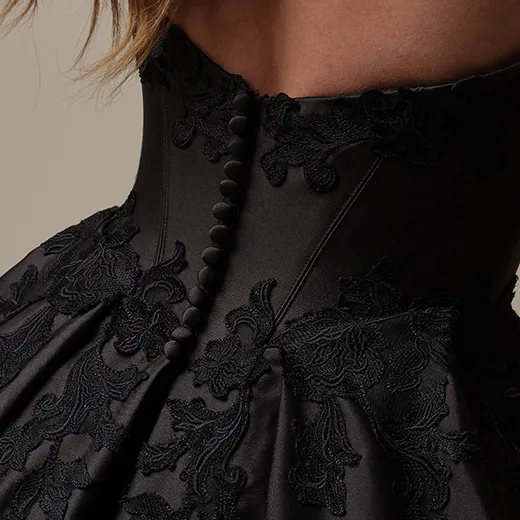 Maggie Sottero Serafina close-up; black satin with lace and buttons on bodice.