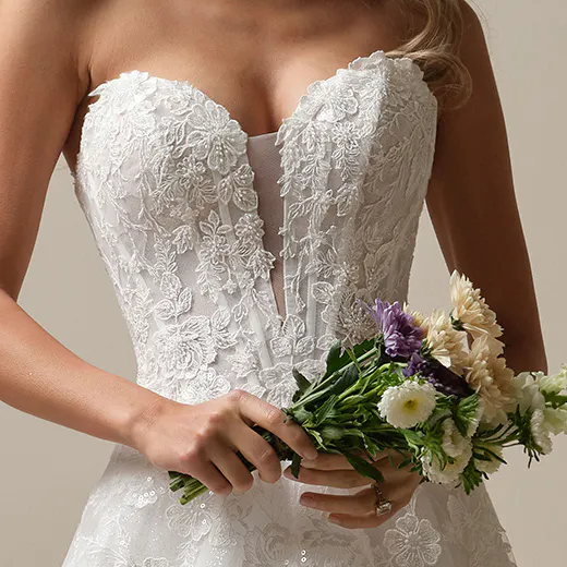 Maggie Sottero Skylar lace bodice dress front view with floral bouquet
