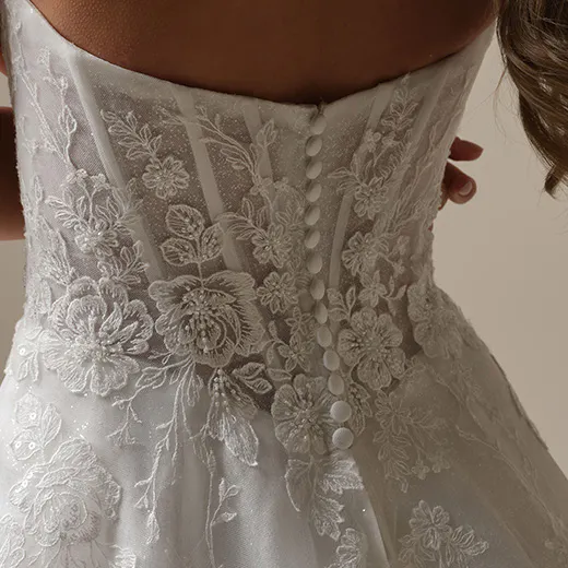 Skylar A-line gown back view with floral lace detail and buttons.