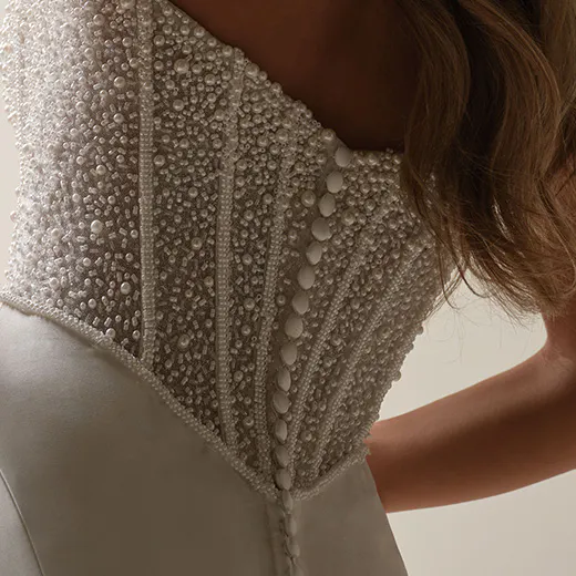 Maggie Sottero Tina Marie mermaid gown, pearl-detailed bodice, side view.