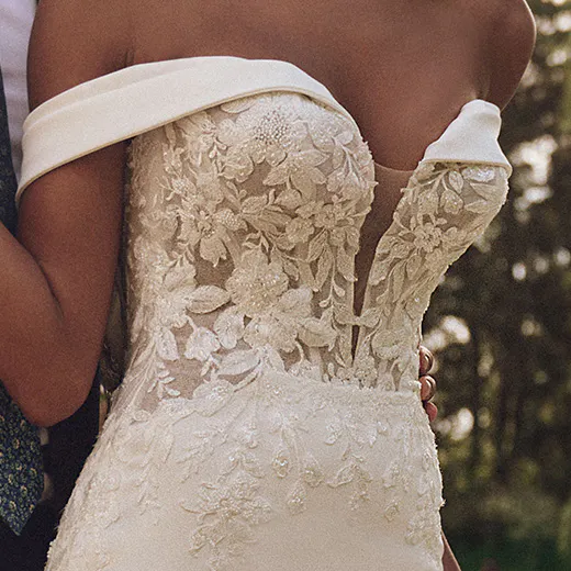 Maggie Sottero Yara front view crepe sheath gown, plunging illusion lace bodice