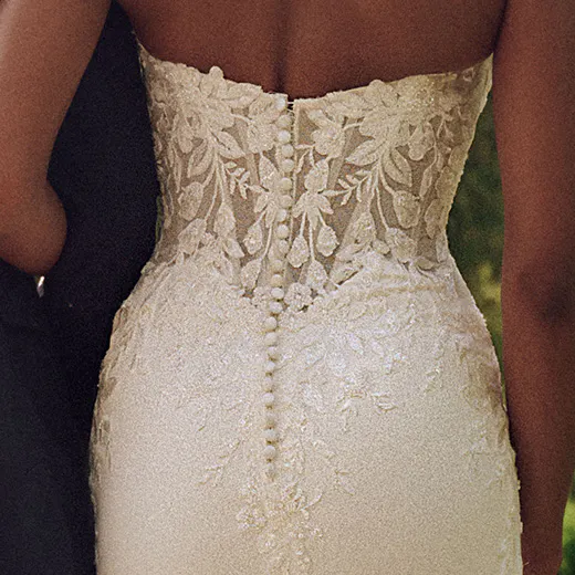 Maggie Sottero Yara back view lace bodice buttons down crepe sheath wedding dress