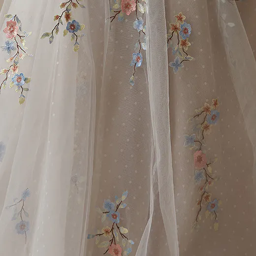 Maggie Sottero Zephyrine floral details on tulle fabric.