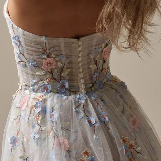 Maggie Sottero Zephyrine back view floral A-line gown with buttons