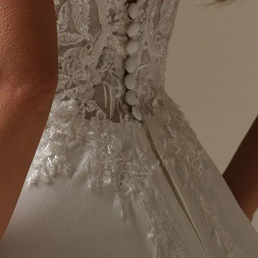 Maggie Sottero Avery back view. Lace bodice, chiffon skirt with buttons.