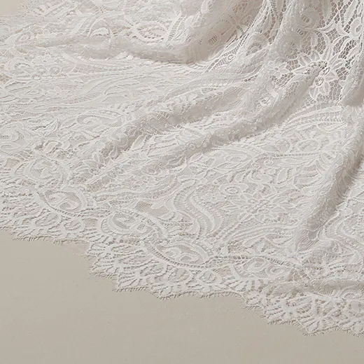 Maggie Sottero Berkeley lace sheath detail, showcasing intricate unembellished pattern.