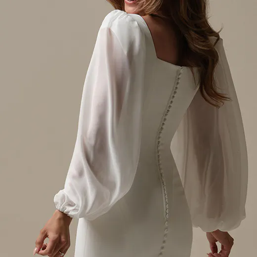 Jorie sheath bridal gown back view with sheer long sleeves by Maggie Sottero.