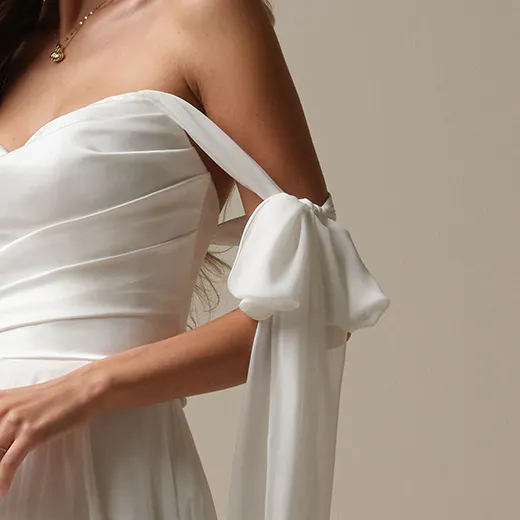 Rebecca Ingram Melody strapless chiffon A-line dress with draped sleeves close-up.