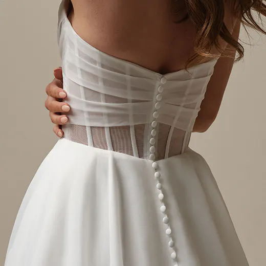 Maggie Sottero Sunny back view, strapless A-line gown with button detail