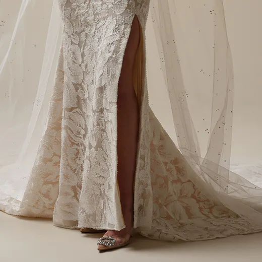 Sottero and Midgley Holland lace sheath bridal gown with side slit and veil detail.