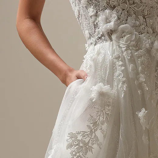 Maggie Sottero Logan front view, lace-up, beaded A-line dress with floral details.