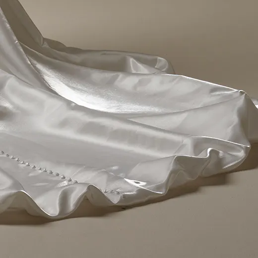Sottero and Midgley Mirabella train detail in satin fabric showing buttons and pleats.