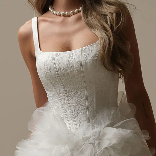 Sottero and Midgley Ross Marie front view, floral bodice, ruffle skirt, pearl necklace.