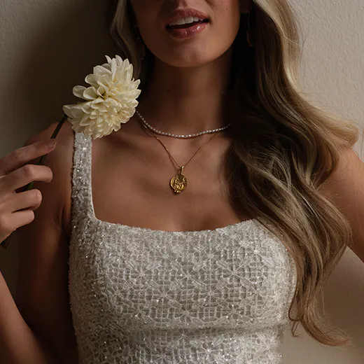 Maggie Sottero star glittering sheath dress detail with flower.