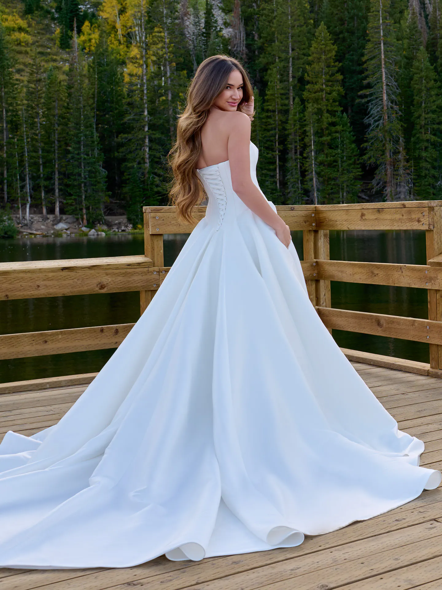 Maggie Sottero Emmanuelle back view strapless wedding dress on deck with forest in background