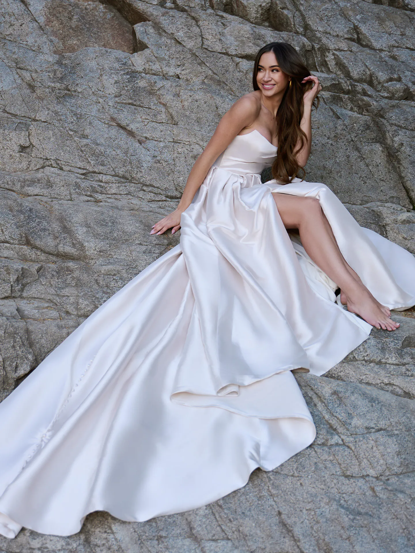 Sottero and Midgley Aspen strapless A-line dress front view on rocky terrain