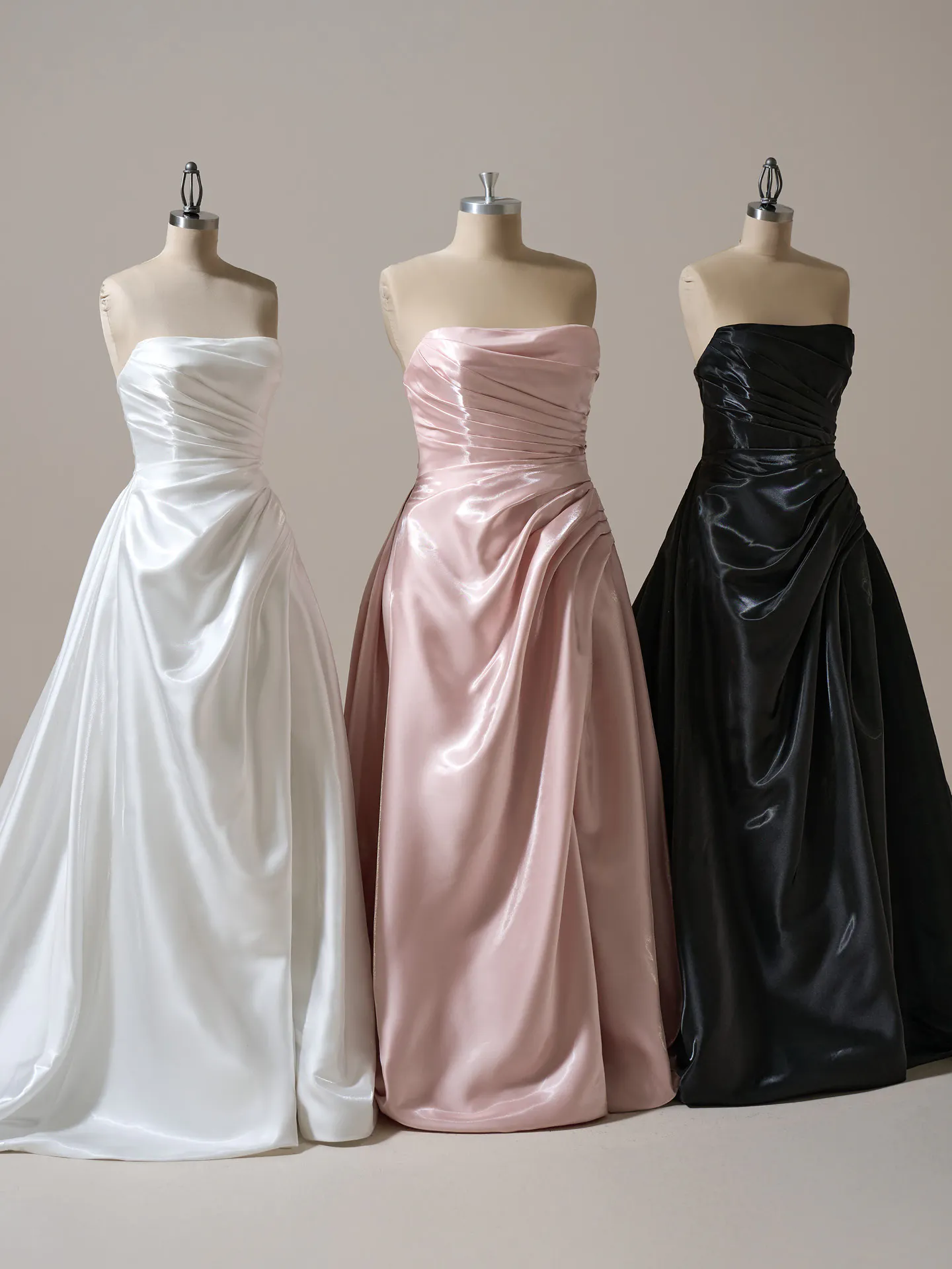 Sottero and Midgley Mirabella asymmetrical pleated A-line gowns in white, pink, black on mannequins
