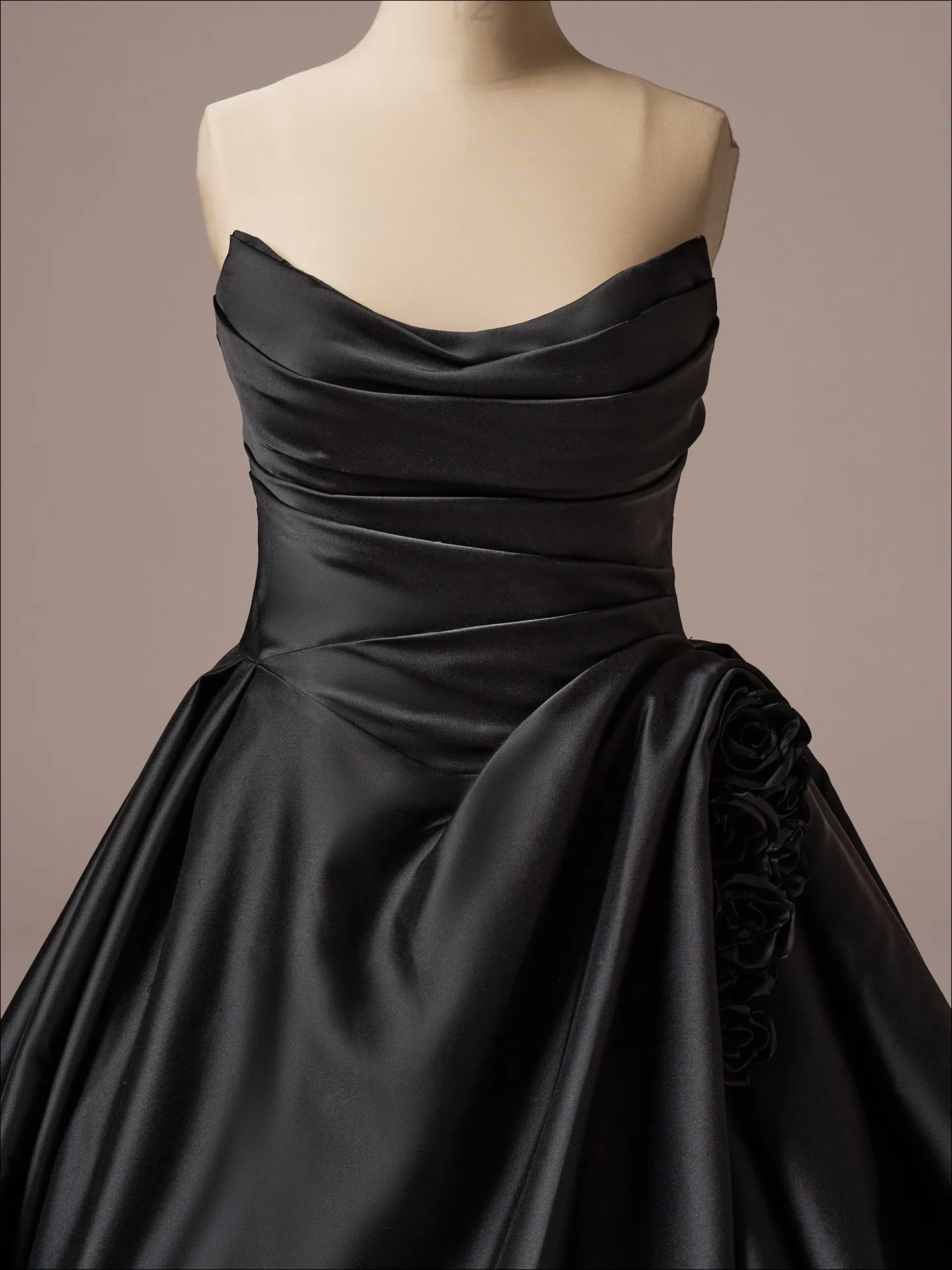 Maggie Sottero Antoinette front view, black ballgown with -D floral detail on waist