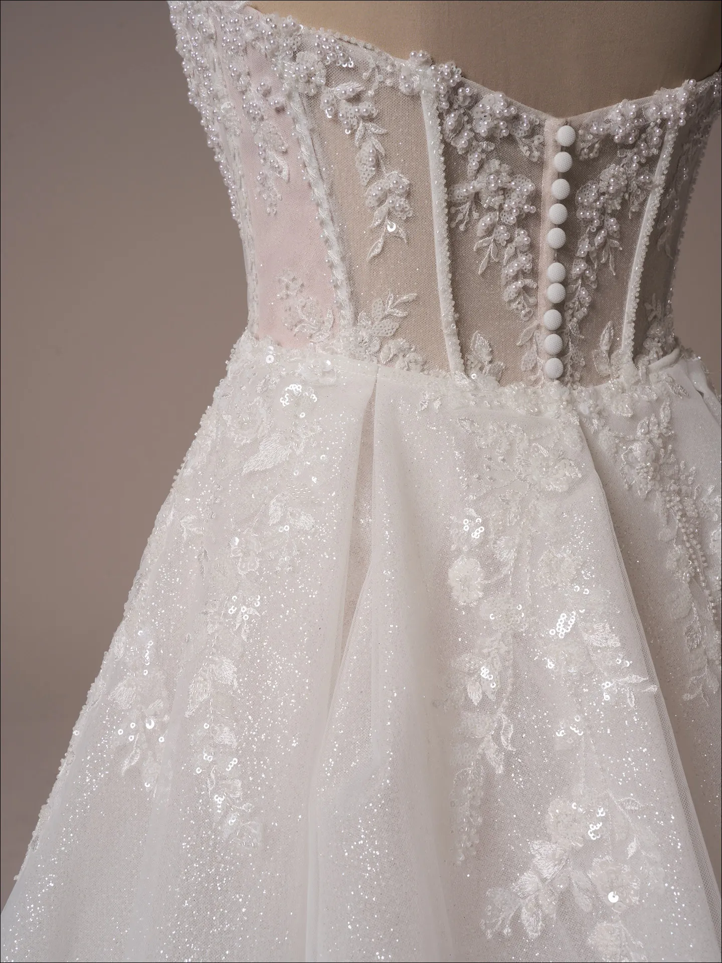 Maggie Sottero Benjie back view beaded mermaid dress with shimmering lace and buttons