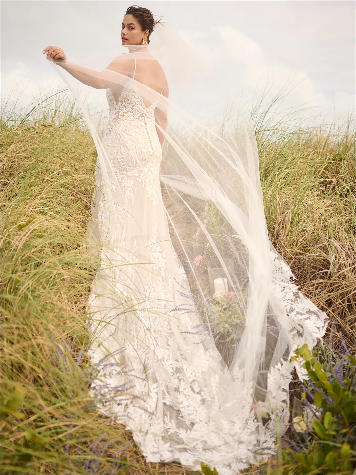 Bianca fit-and-flare gown back view in grassy field with flowing veil