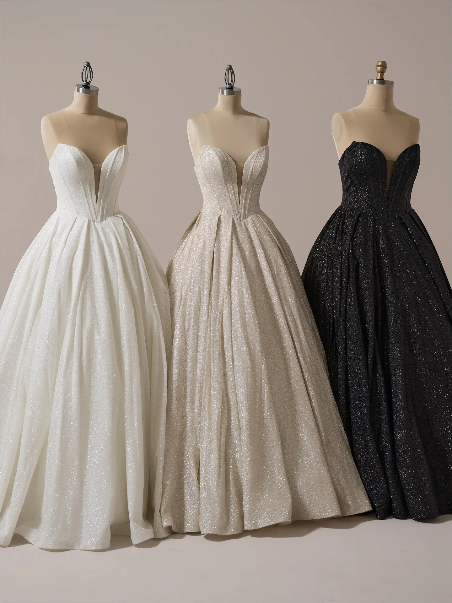 Maggie Sottero Derrick Royale ballgowns on mannequins, sparkly plunge neck, front view