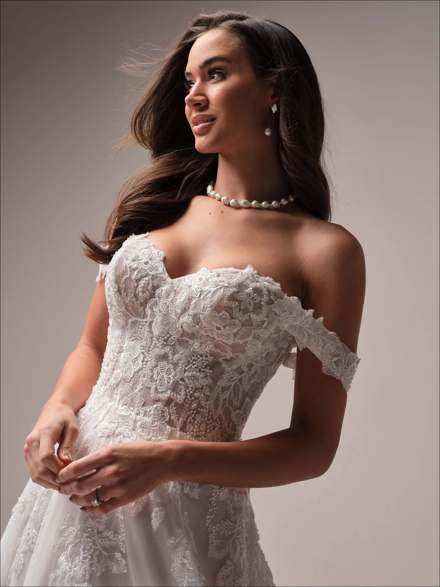 Maggie Sottero Everleigh side view off-the-shoulder lace A-line bridal dress