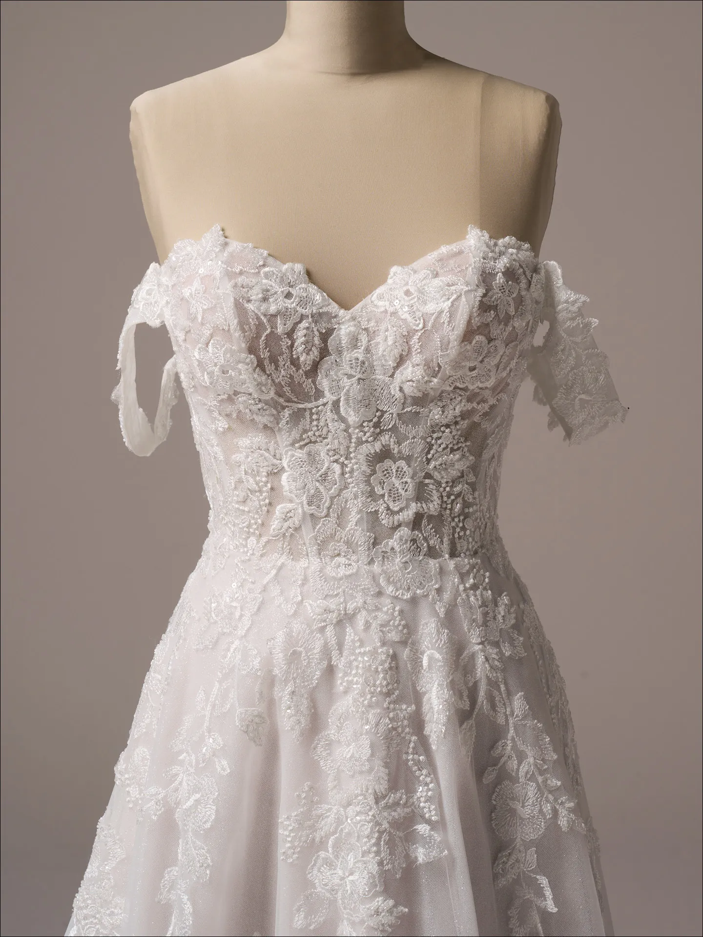 Maggie Sottero Everleigh front view, off-the-shoulder lace A-line bridal dress