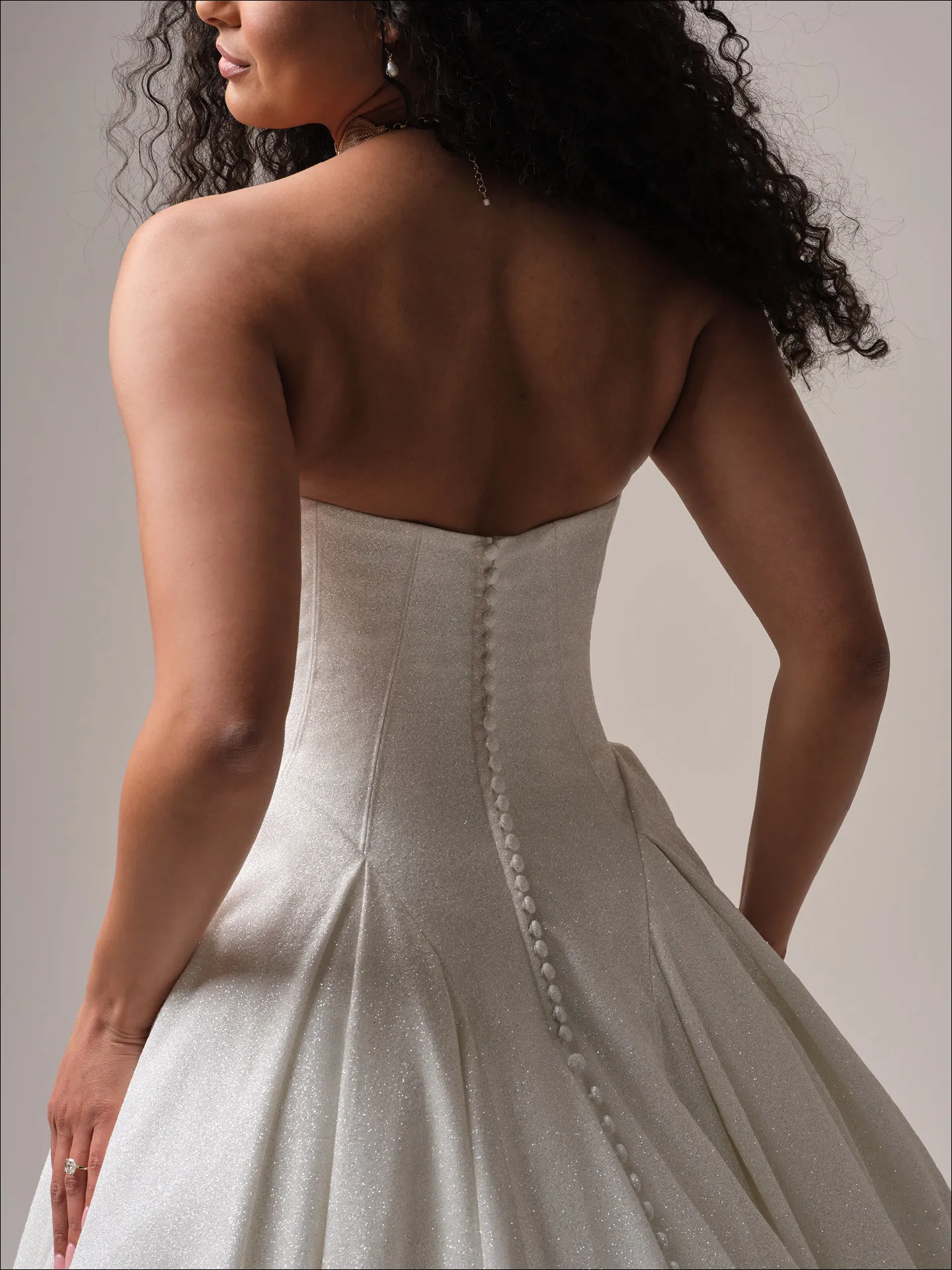 Maggie Sottero Fortune Royale back view ballgown with sparkly fabric and button details