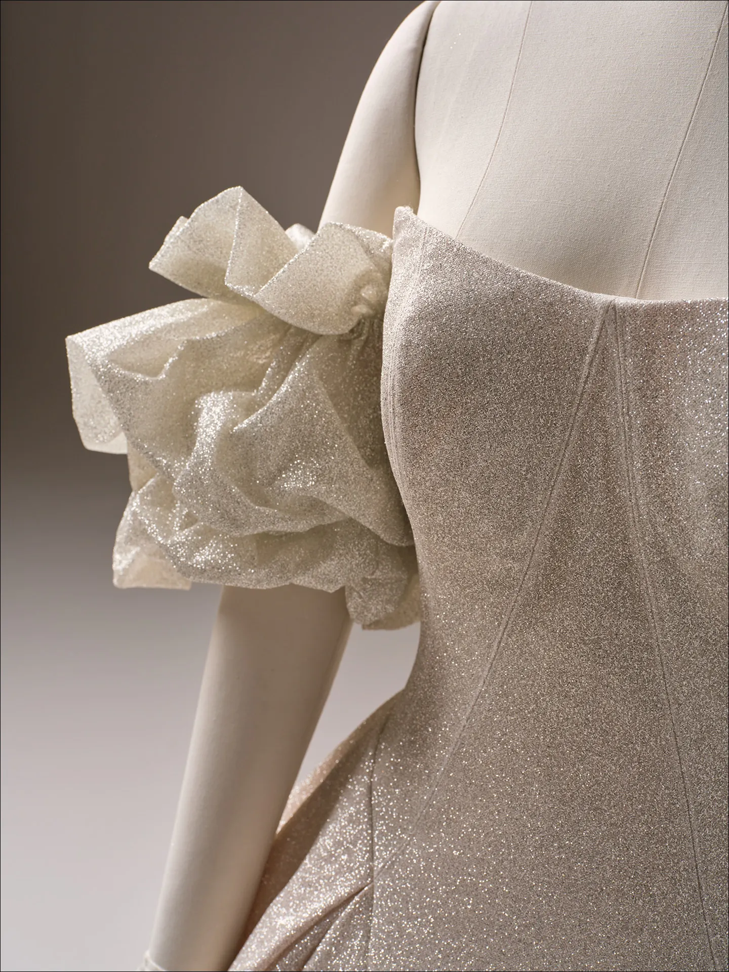 Maggie Sottero Fortune Royale sparkly ballgown close-up showing ruffled sleeve detail