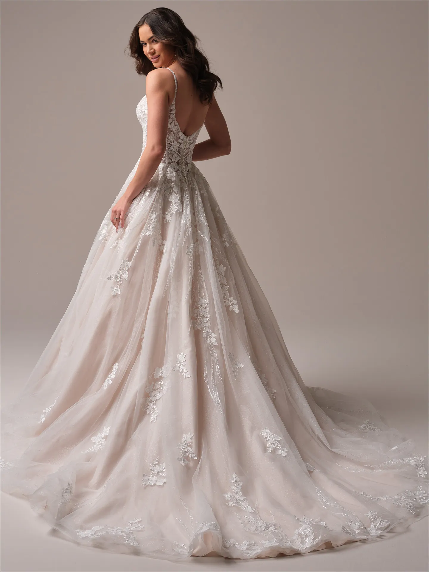 Maggie Sottero Juneau ballgown wedding dress back view with long tulle train spread