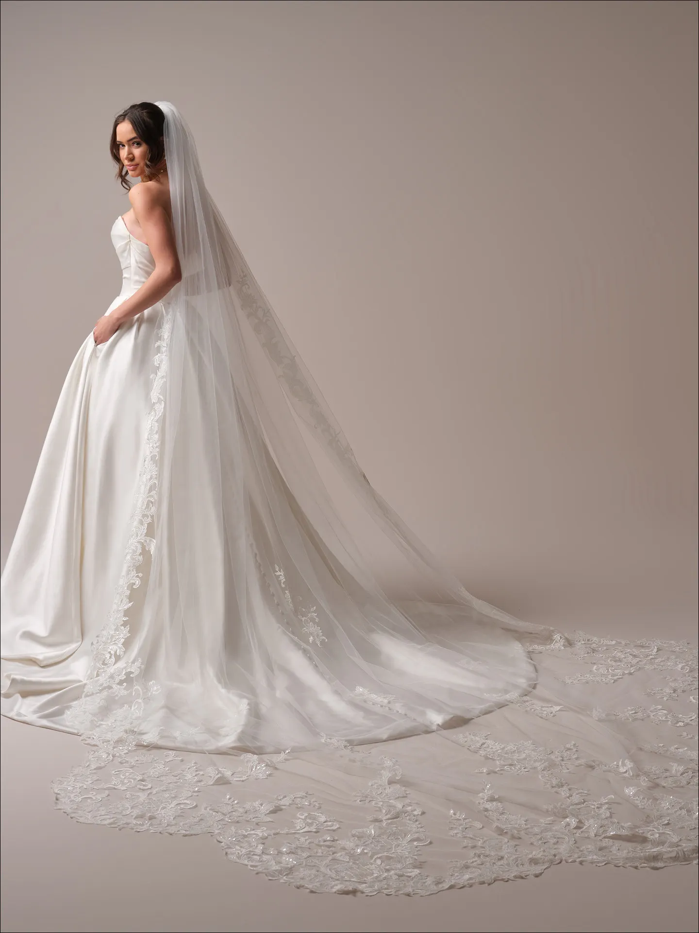 Maggie Sottero Maureen ballgown wedding dress back angle with flowing skirt train