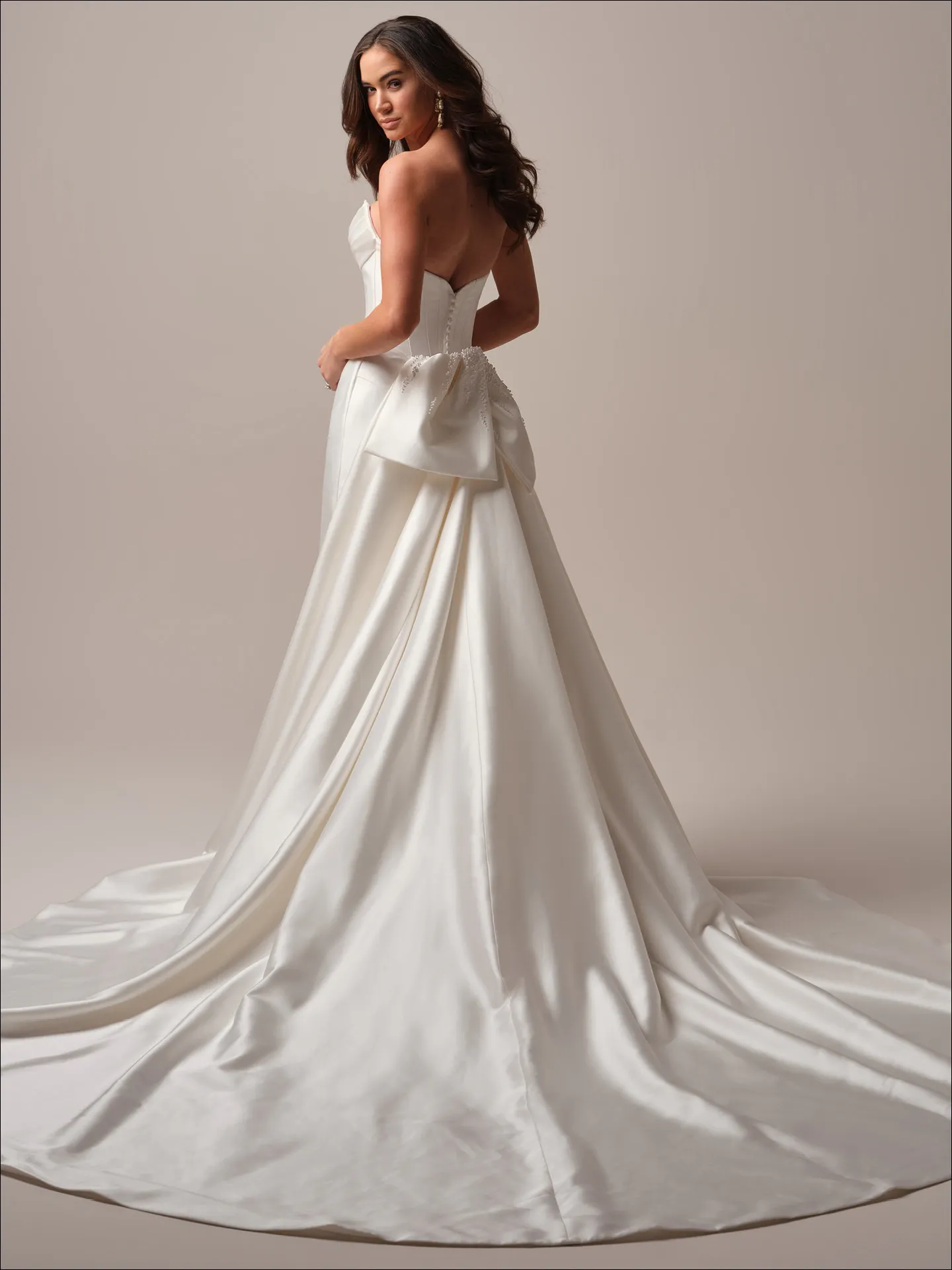 Maggie Sottero Melissa fit and flare wedding dress side view with sleek contour